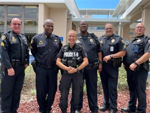 Fellow officers congratulate Officer Baugher